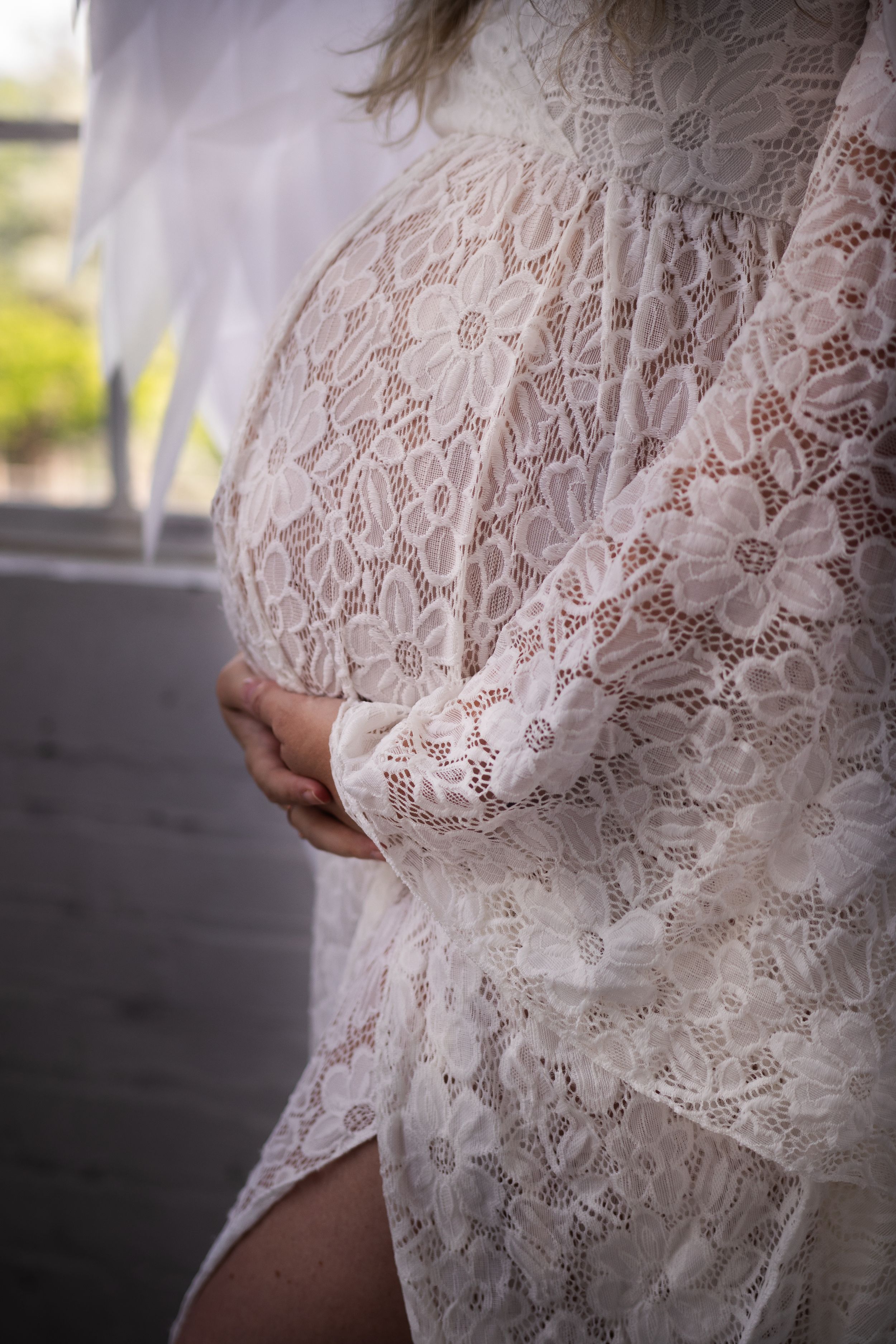 Close-up detail shots of delicate white lace fabric with intricate floral patterns and scalloped edges.