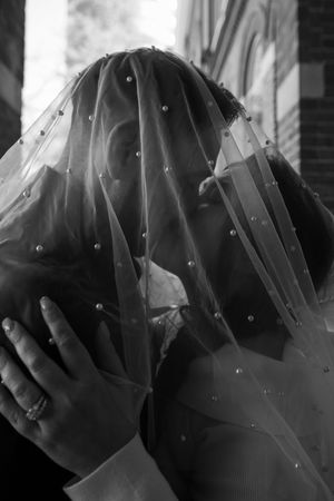 Black and white close-up shots of a delicate bridal veil with sparkling details.