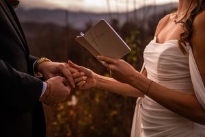 Close-up shots of hands exchanging wedding rings during an intimate ceremony.