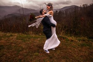 A couple shares a romantic embrace against a misty mountain backdrop in a series of candid moments.