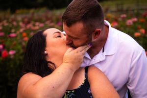 Intimate moment captured in garden with blooming flowers at dusk.