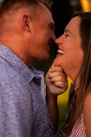 A romantic sequence of close-up shots showing a couple laughing and sharing an intimate moment outdoors.