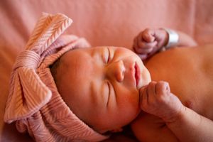 Close-up view of sleeping infant with delicate features in natural light.