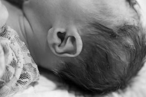 Black and white close-up of sleeping baby's facial features.