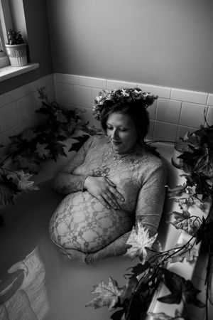 Artistic black and white photos showing a figure reclining among decorative leaves and flowers.