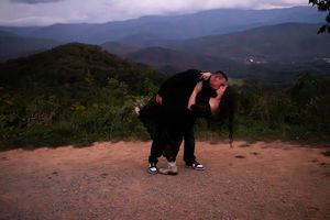 A sequence of photos shows someone proposing on a scenic mountain overlook at sunset.