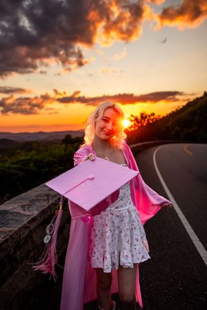 A series of sunset photos featuring pink graduation cap silhouettes against a dramatic orange and purple sky.