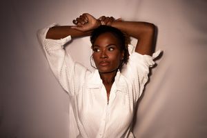A series of six fashion portraits featuring someone wearing a white shirt against a dark background.