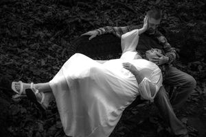 A series of black and white dance performance photos showing graceful movements and flowing white costumes.