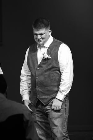 Person in formal vest and white shirt shown in dramatic black and white portrait series.