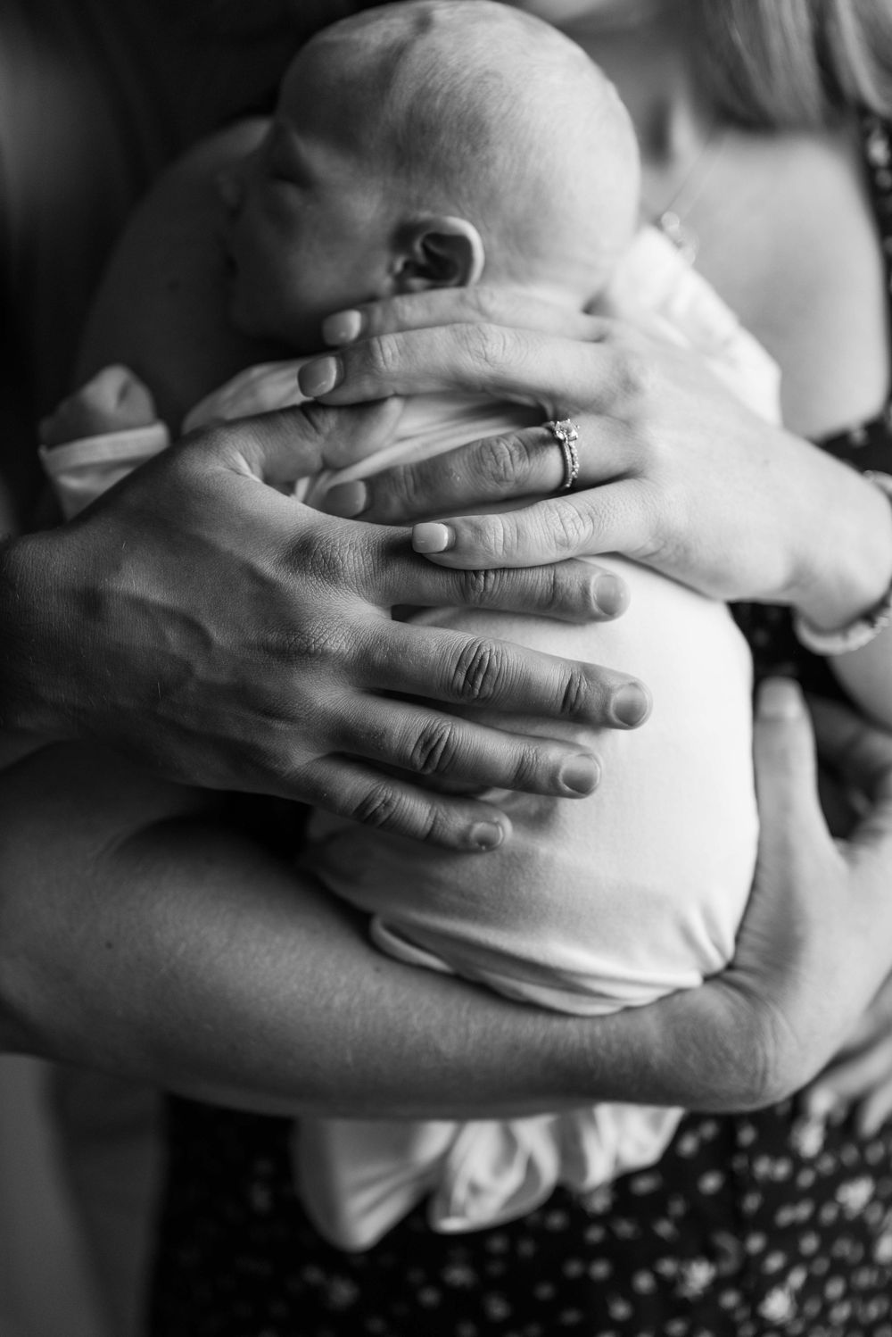 Black and white close-up sequence of hands cradling a pregnant belly.