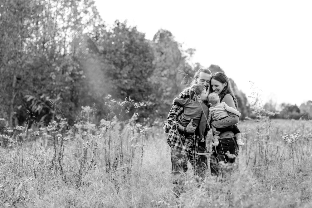 Black and white landscape photo of people in a serene field setting.