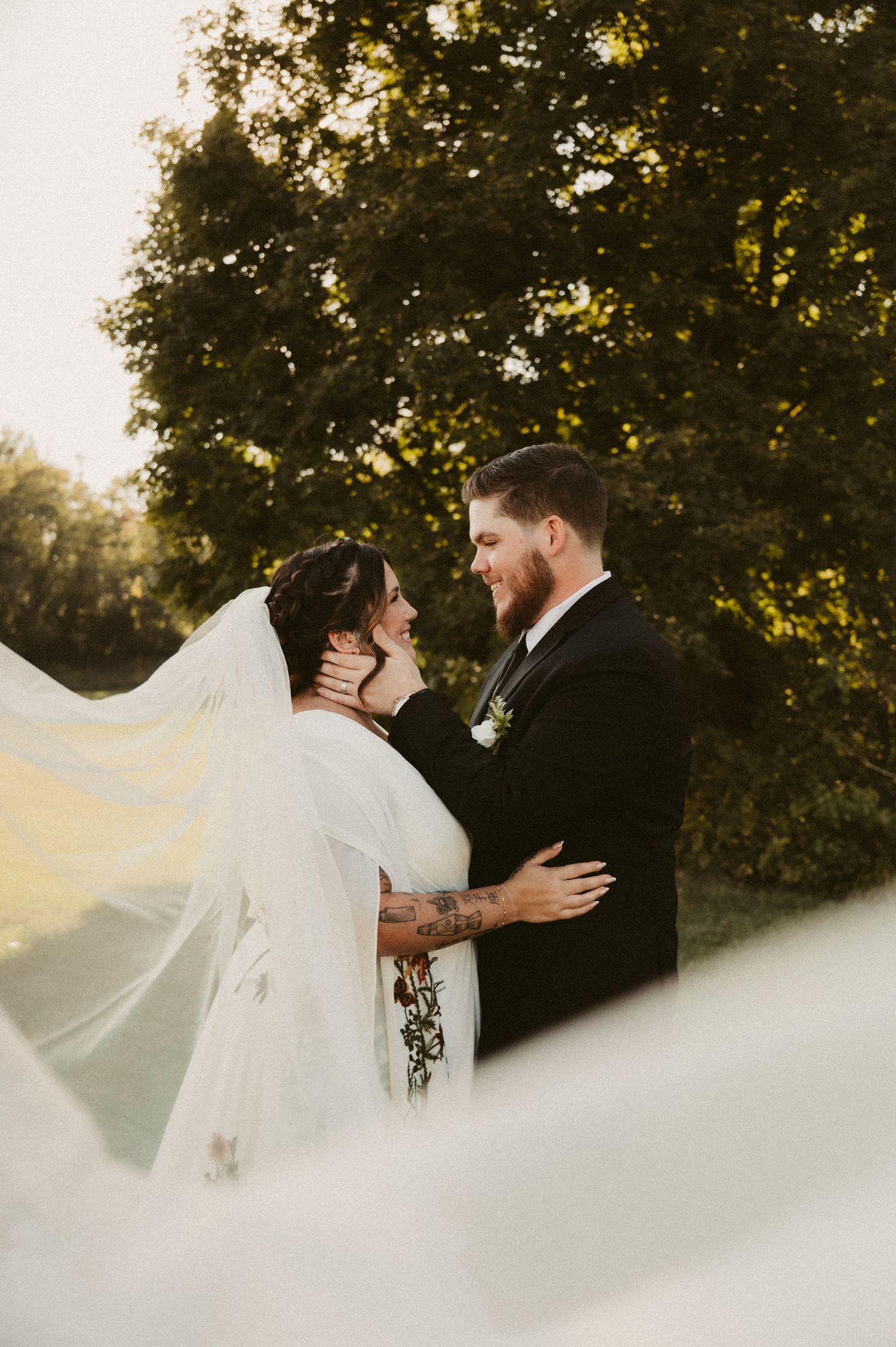Indiana Wedding and Elopement Photographer // Romantic wedding portrait with flowing veil against a backdrop of autumn trees.
