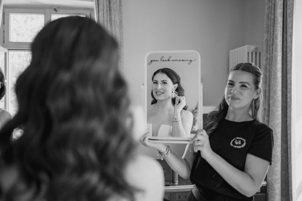 A series of black and white wedding photographs showing intimate moments during a couple's special day.