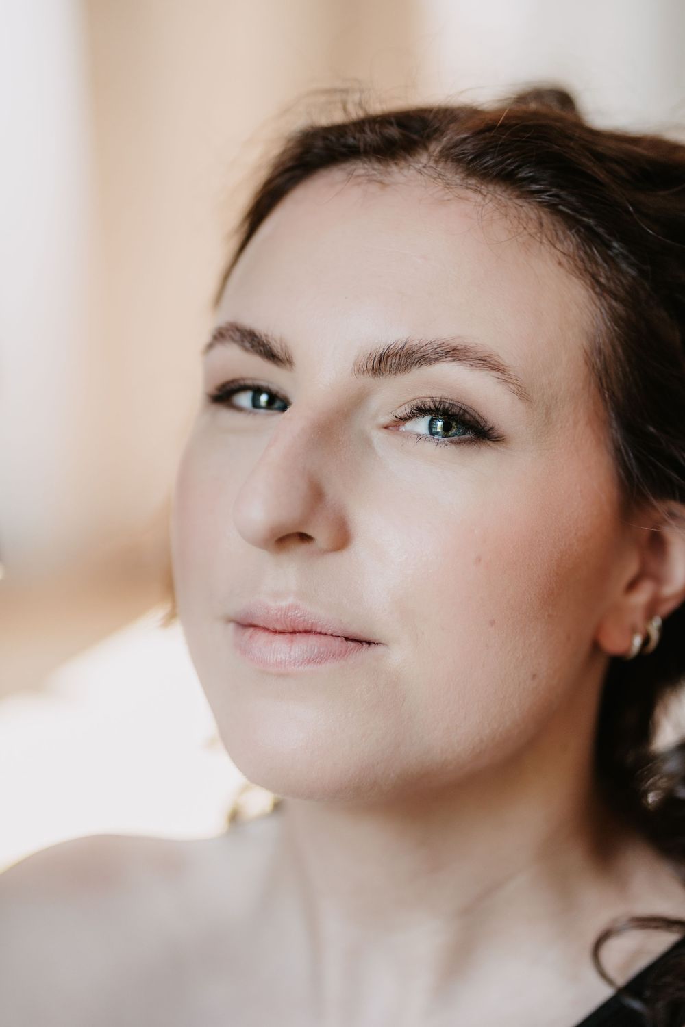 Close up portrait with soft natural lighting showing gentle expression and luminous skin.