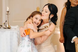 Wedding guests dance and celebrate during a joyous reception in an elegant ballroom.