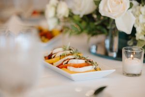 Elegant wedding reception table settings with soft floral centerpieces and glowing candlelight create a romantic atmosphere.
