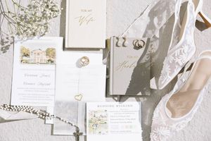 Wedding stationery and invitation designs displayed in a soft neutral color palette with floral elements and calligraphy details.
