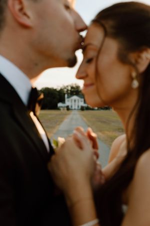 A romantic wedding couple shares intimate close-up moments during golden hour at a Southern plantation venue.
