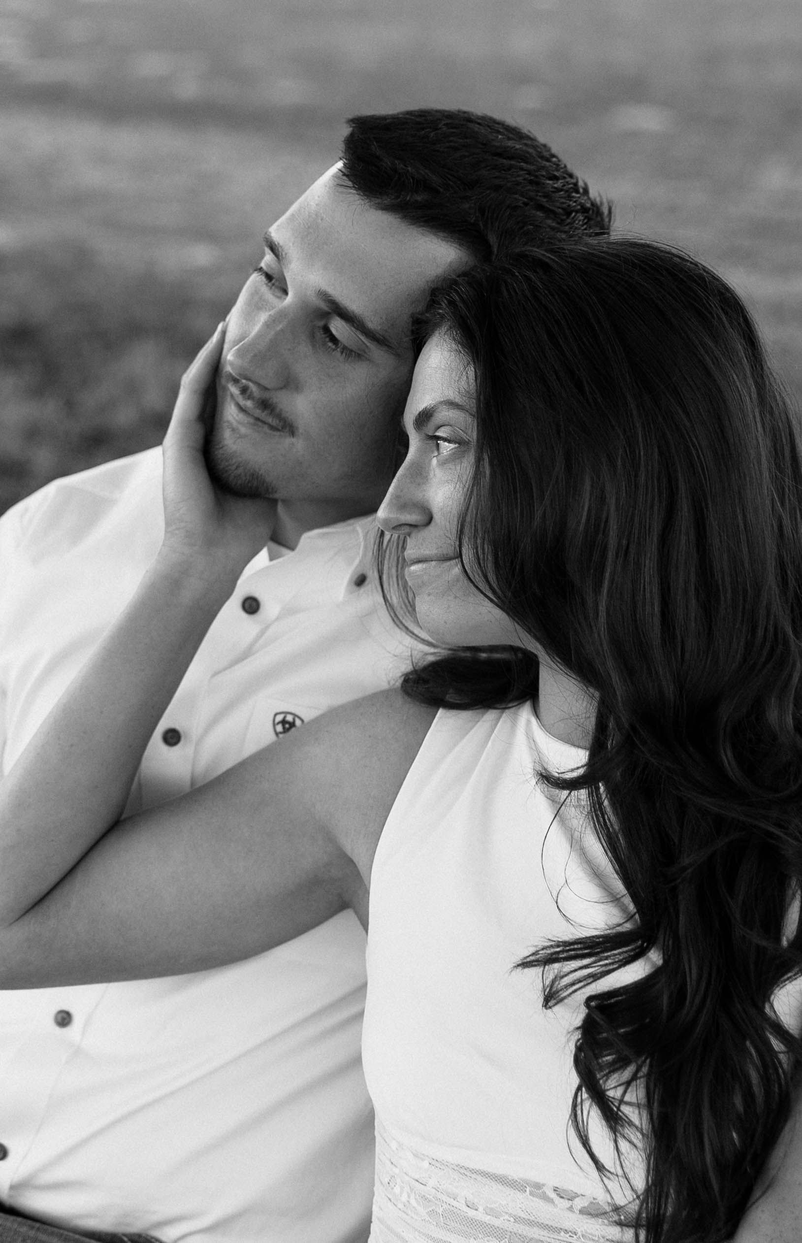 A romantic black and white photo sequence showing a tender kiss between a couple in white clothing.