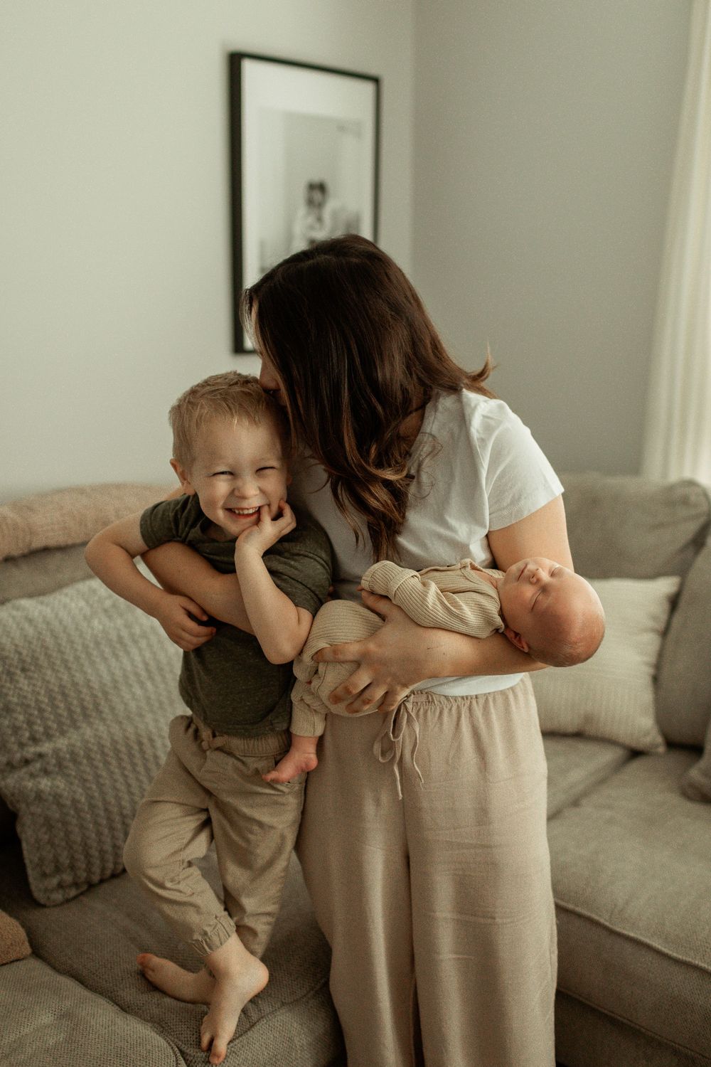 A series of candid photos showing playful hugging moments on a cozy gray couch in a bright room.