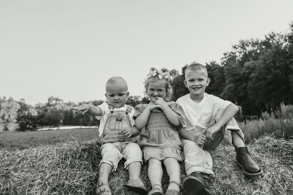 A series of black and white vintage photographs showing children playing outdoors in a rural setting.