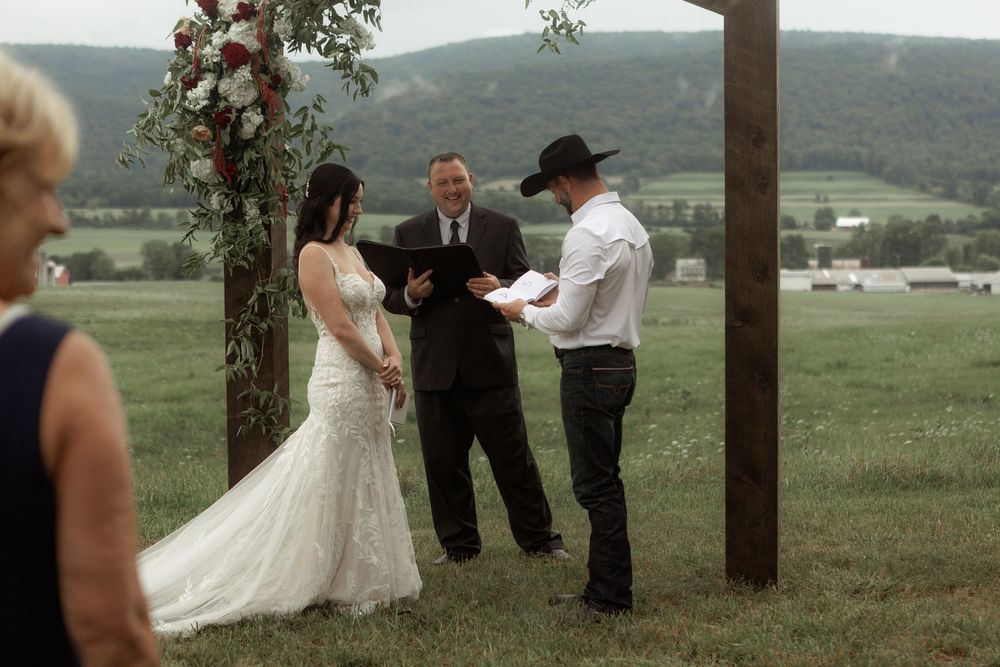 A panoramic sequence of wedding ceremony moments captured outdoors on a hillside with mountains in the background.