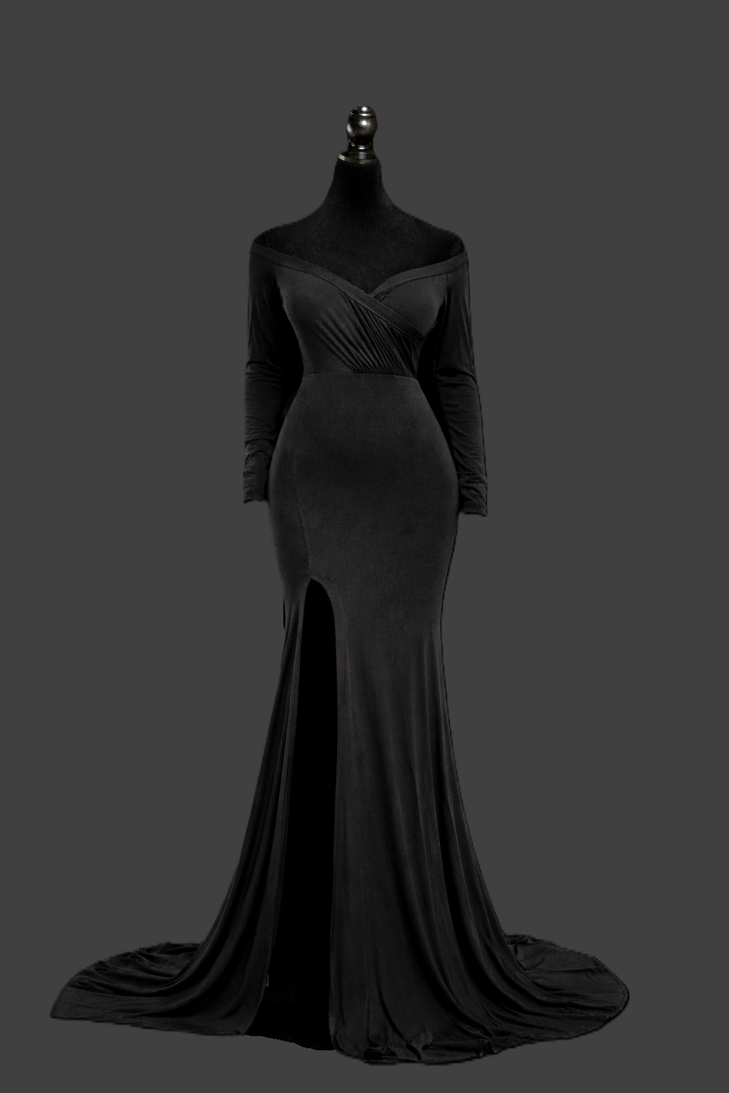 A long black formal evening gown displayed on a dark background showing its elegant silhouette and flowing train.