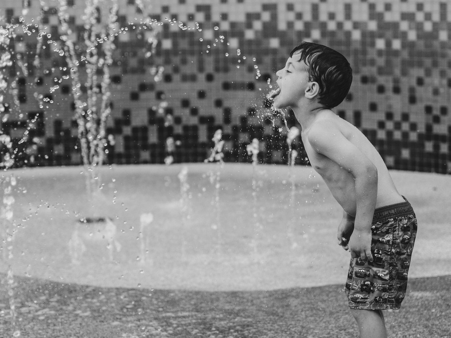 Black and white photos of water splashing and playing in a fountain.