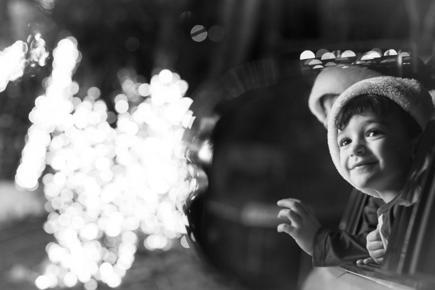A series of black and white portraits with dramatic lighting and bokeh effects.