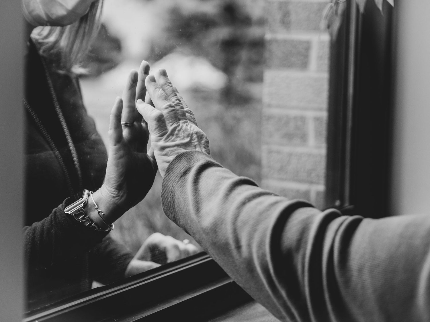 Black and white series showing hands reaching through car windows.