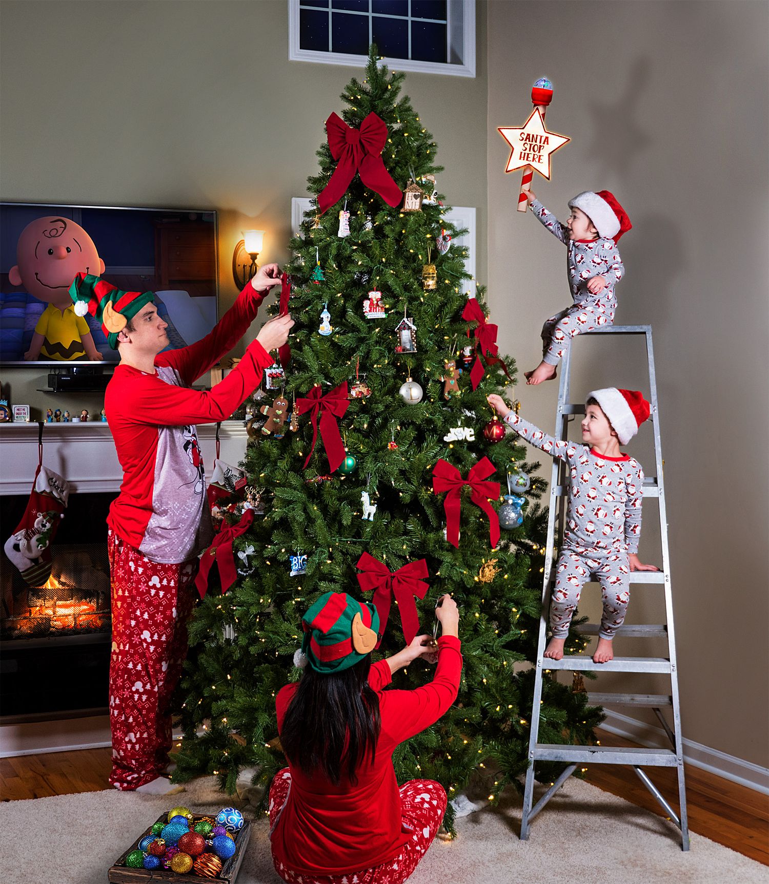 A sequence showing the decorating of a Christmas tree with ornaments and a ladder.
