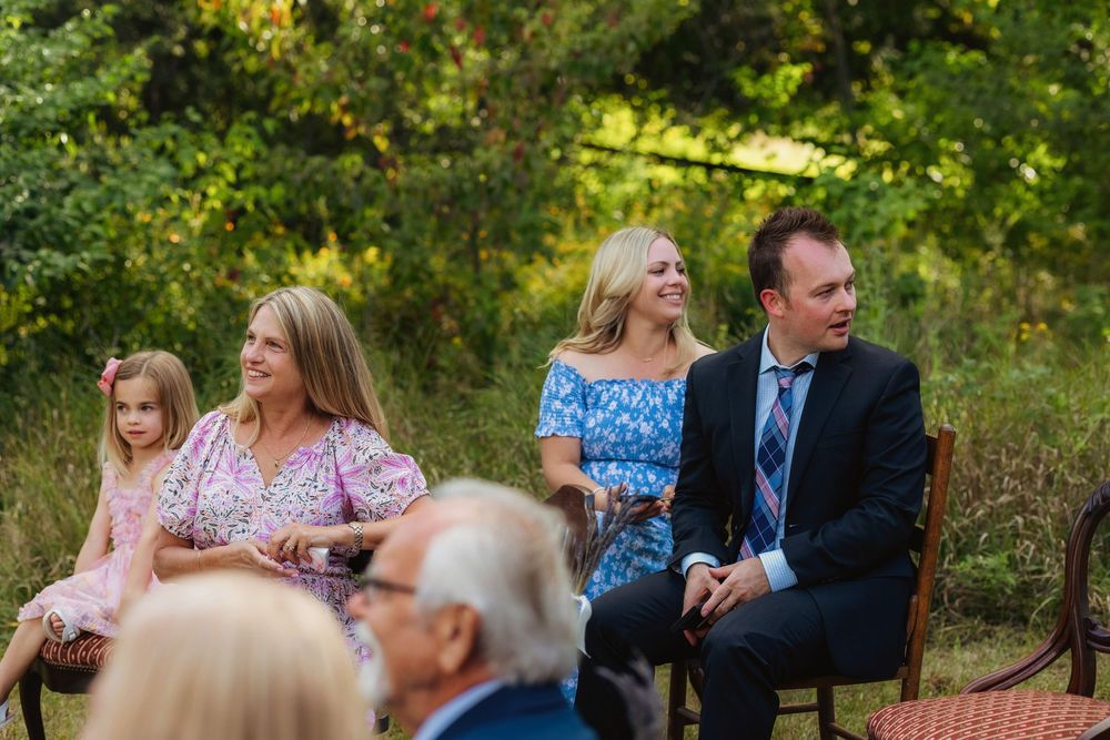 A series of candid outdoor photos showing people sitting and conversing on benches in a garden setting at a wedding ceremony