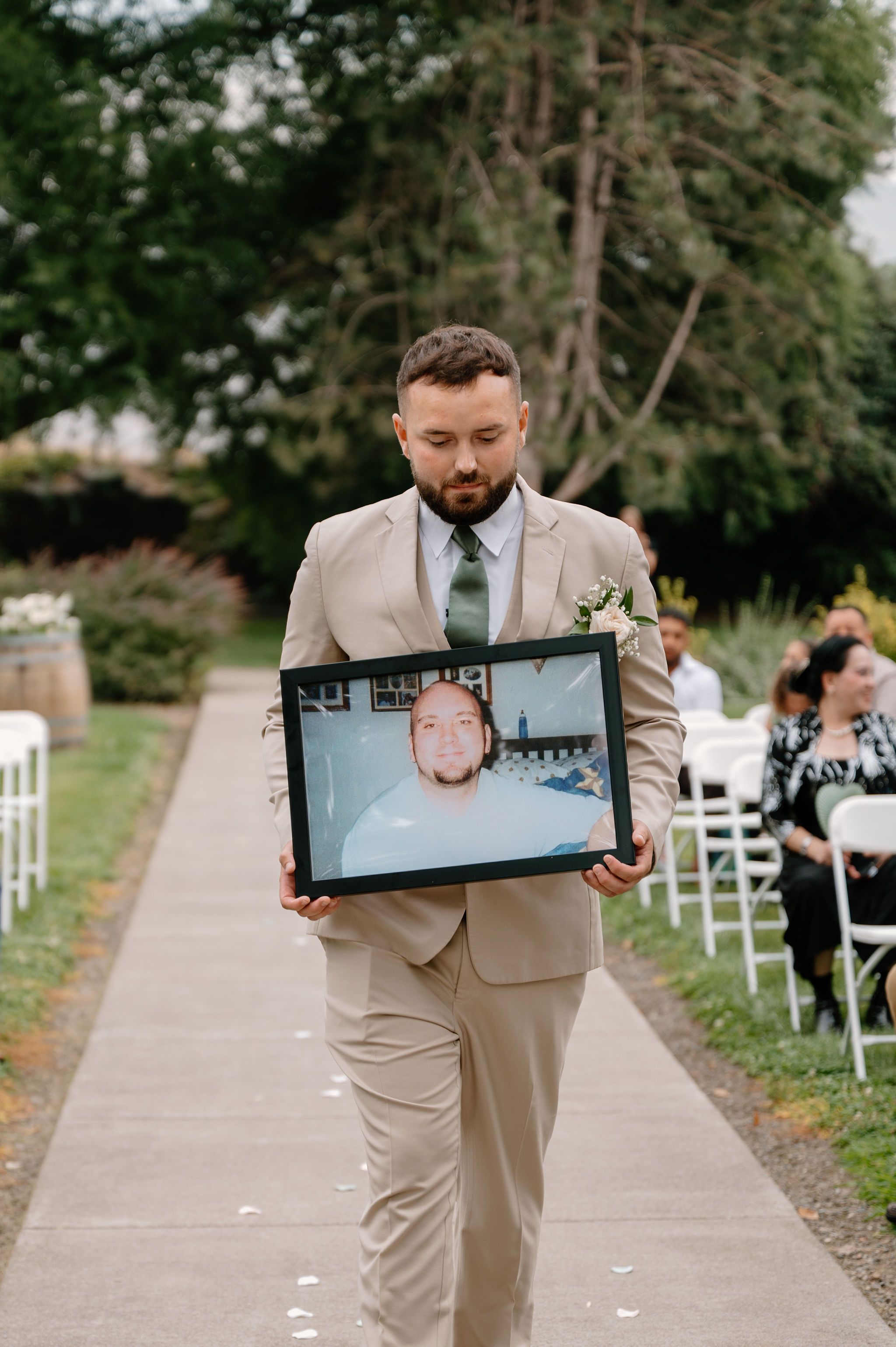 Groom carries photo of dad down the aisle during Shadow Lake Ranch wedding ceremony