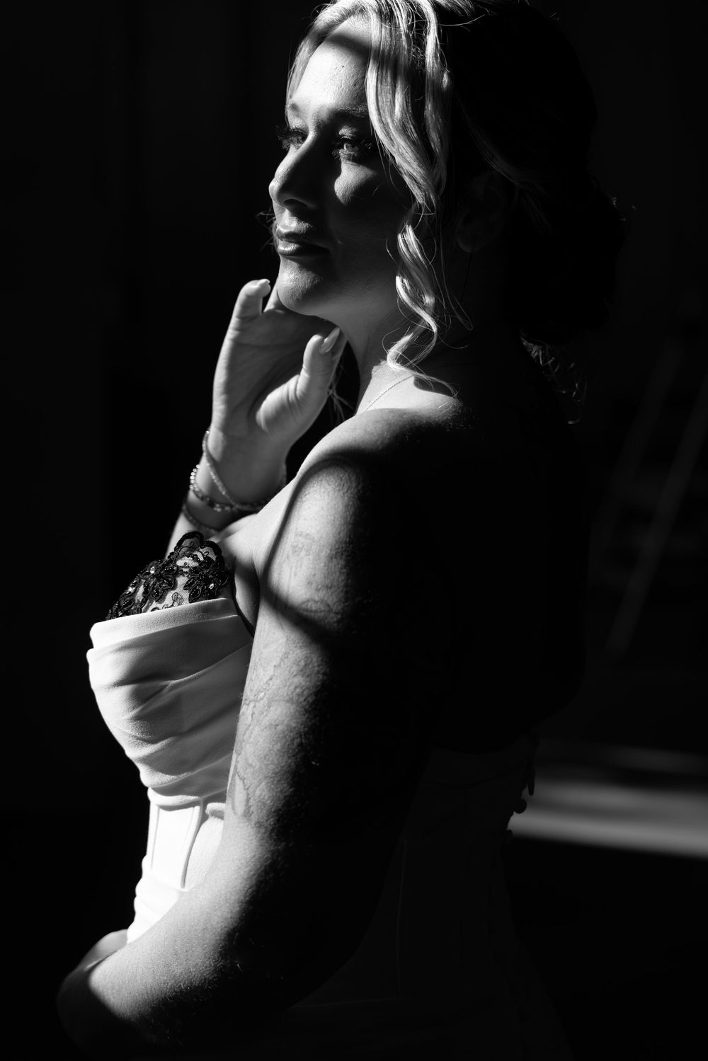 Dramatic black and white portrait series showing silhouetted profile in contrasting shadow and light.