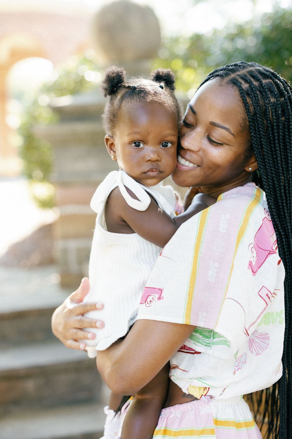 A tender moment shared between parent and child showing love and affection in an outdoor setting.