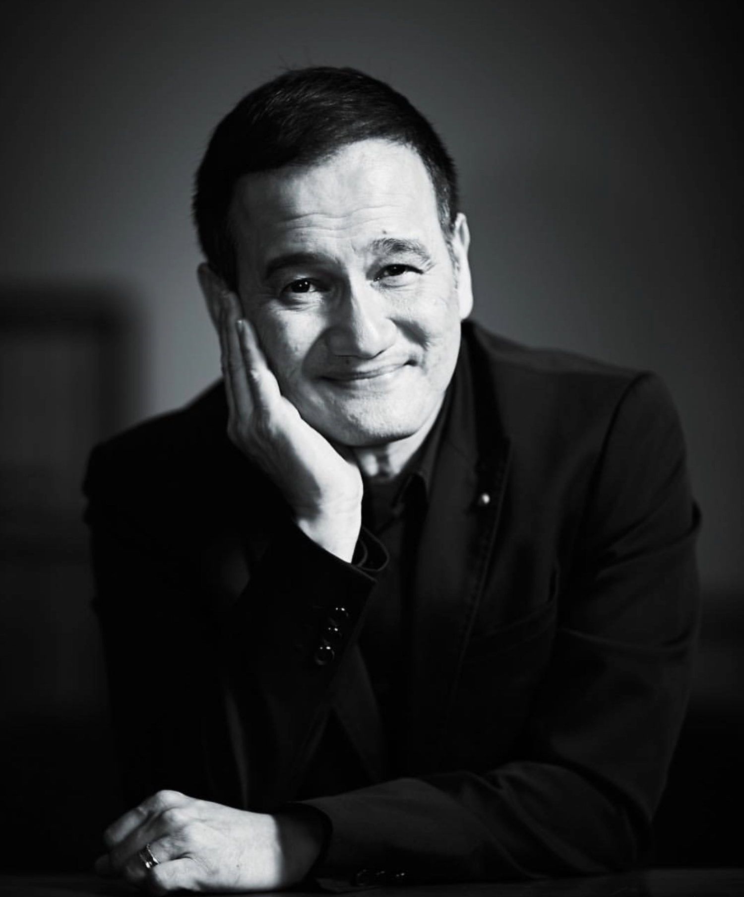 Black and white headshots showing range of emotions and expressions.