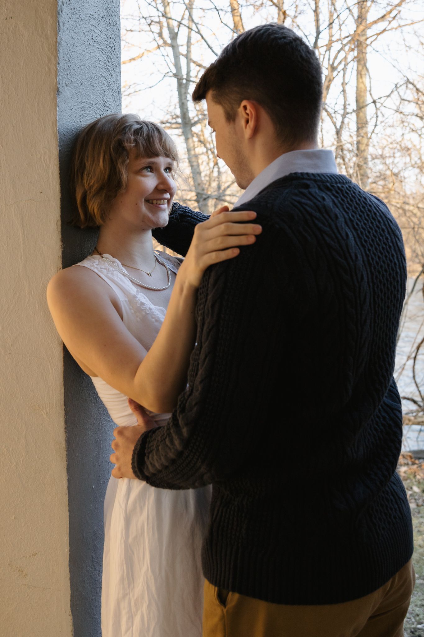 Man staring lovingly into woman's eyes in a Greek Revival Shelter at Island Park in Ann Arbor