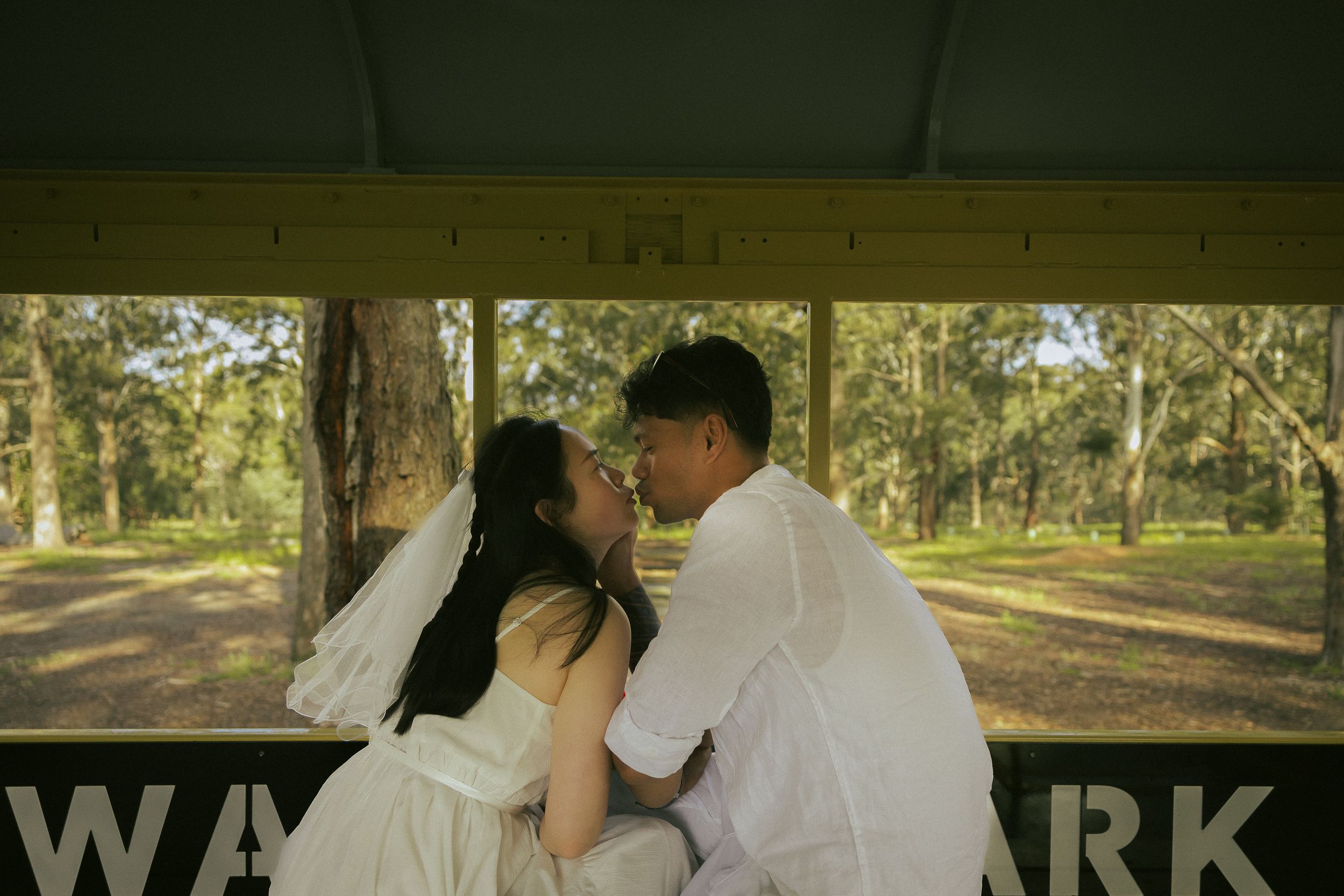 A series of romantic engagement photos showing a couple embracing in a sunlit park setting.