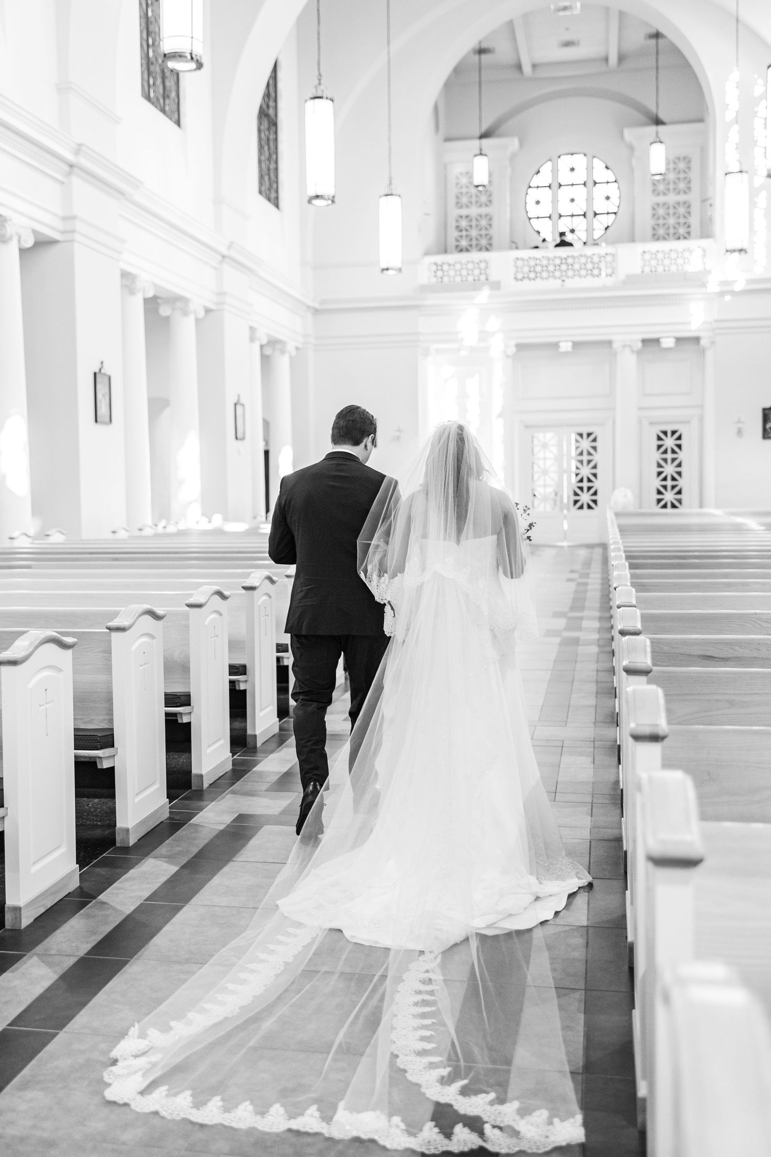 Black and white sequence of a bride and groom walking down the aisle of an elegant white church interior.