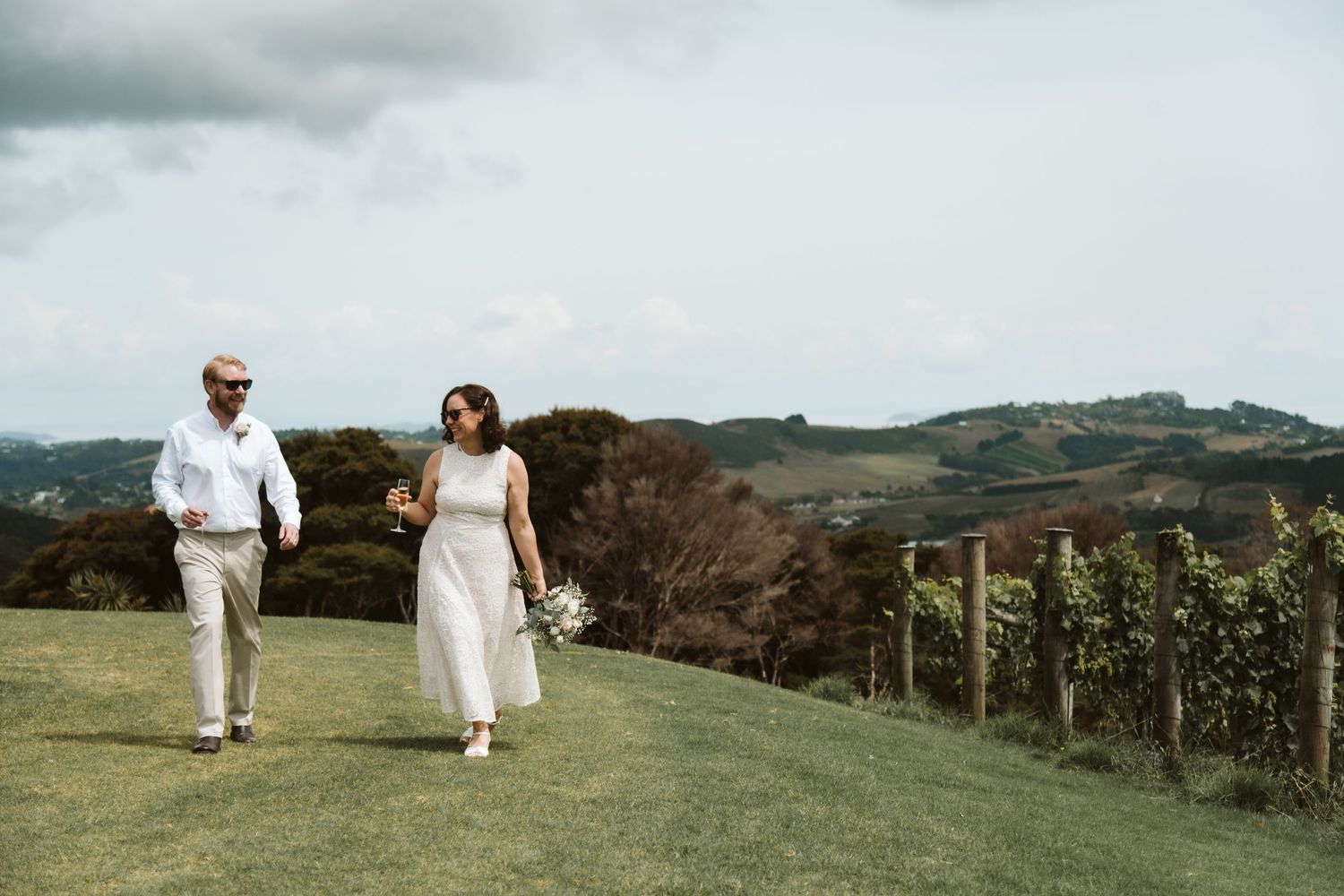 A collage of beach wedding photos showing newlyweds walking along sandy shores with turquoise ocean views.