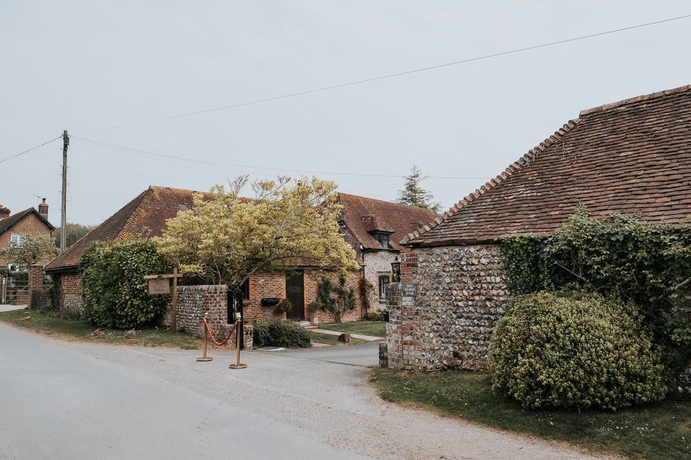 A series of connected panoramic photos showing old stone buildings and rural village houses along a country road.