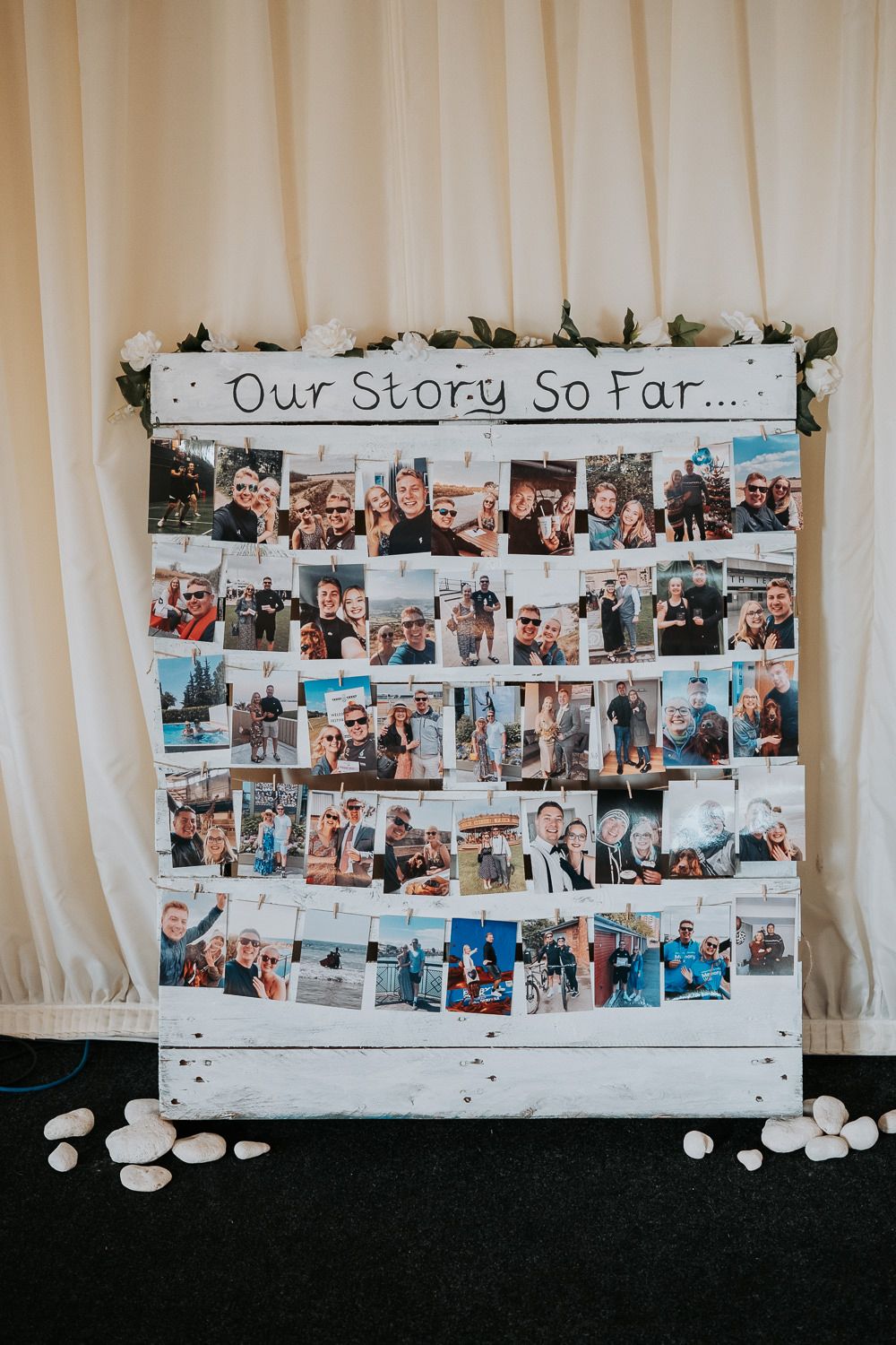 A photo collage wall display titled 'Our Story So Far' featuring multiple personal photographs arranged on a white background.