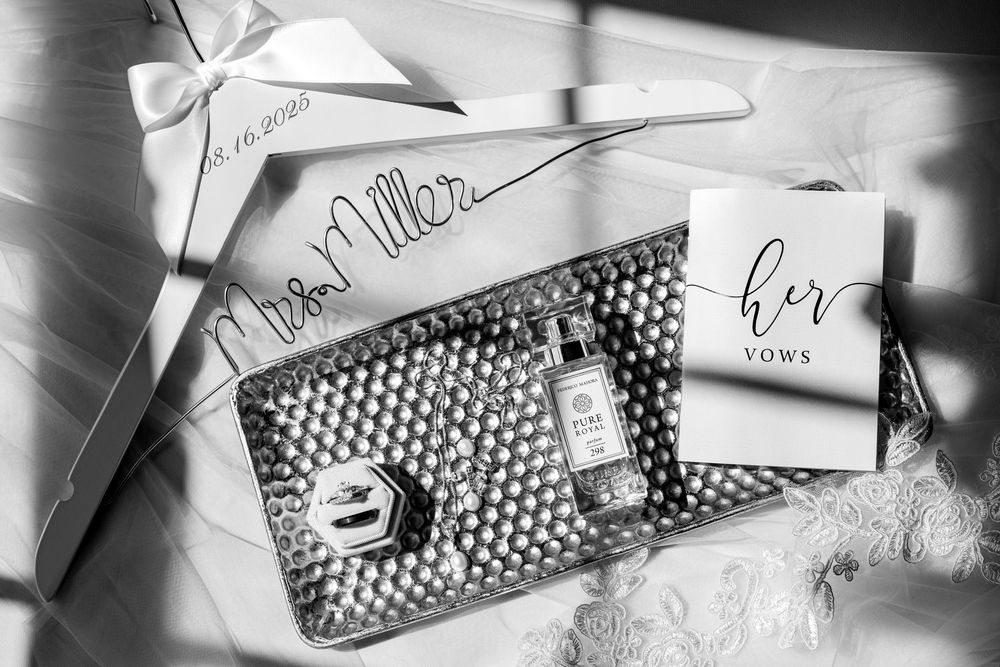 Black and white wedding details including a textured clutch and handwritten cards.