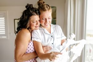 Mom and daughter look at wedding dress together