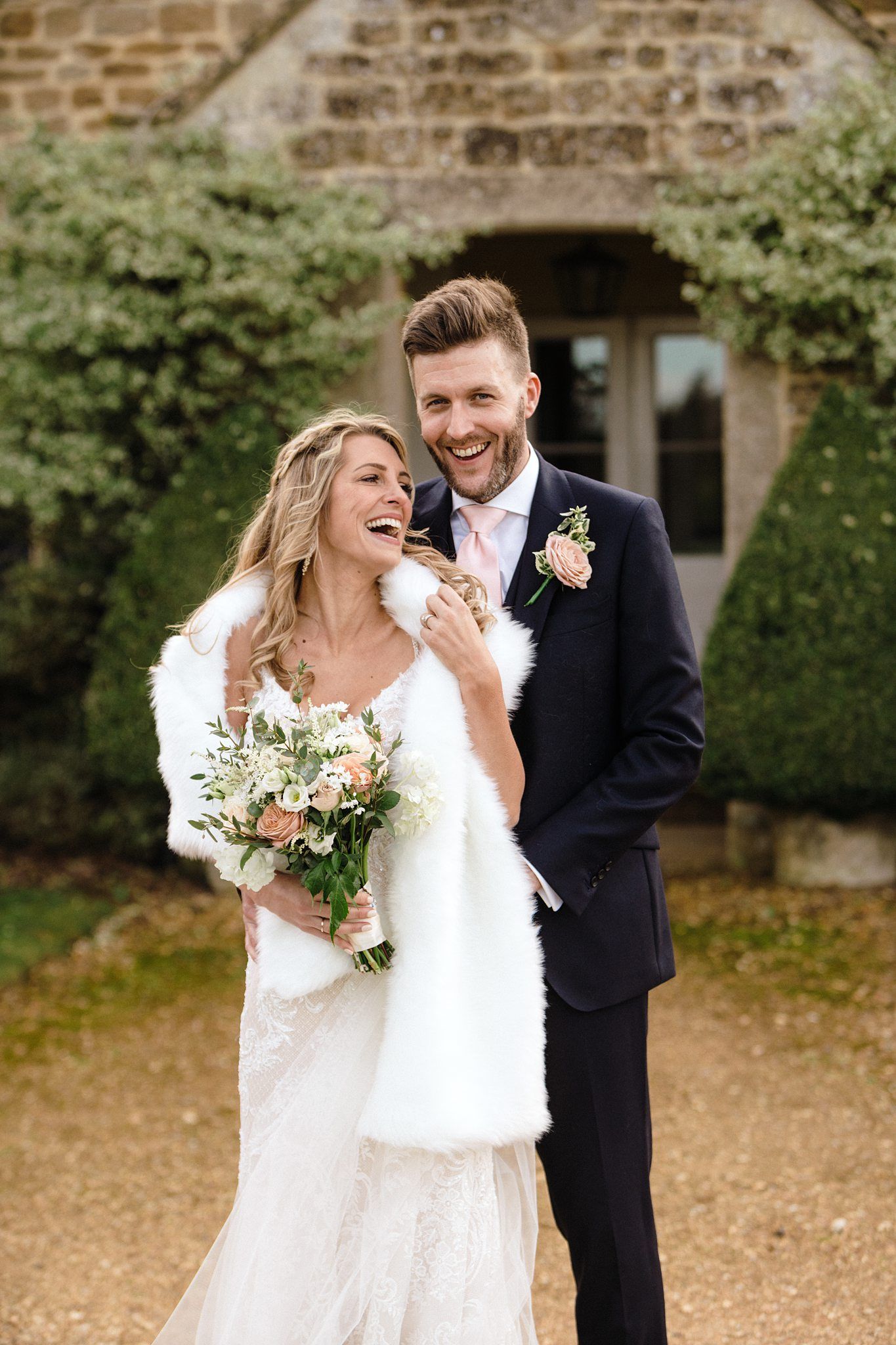 Editorial winter wedding photography style by Nova Scotia wedding photographer of couple laughing together during pictures.