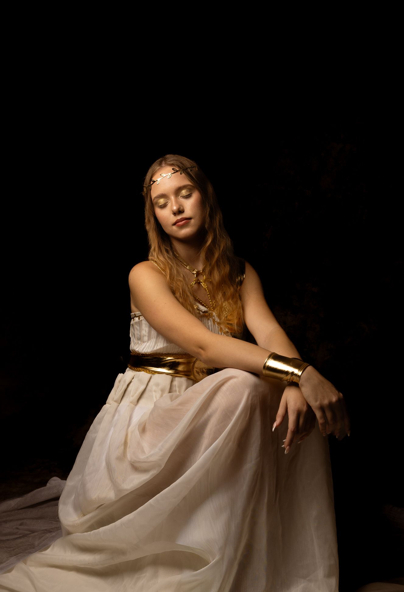Hippolyta, Queen of the Amazons, girl in white sitting with eyes closed, black background