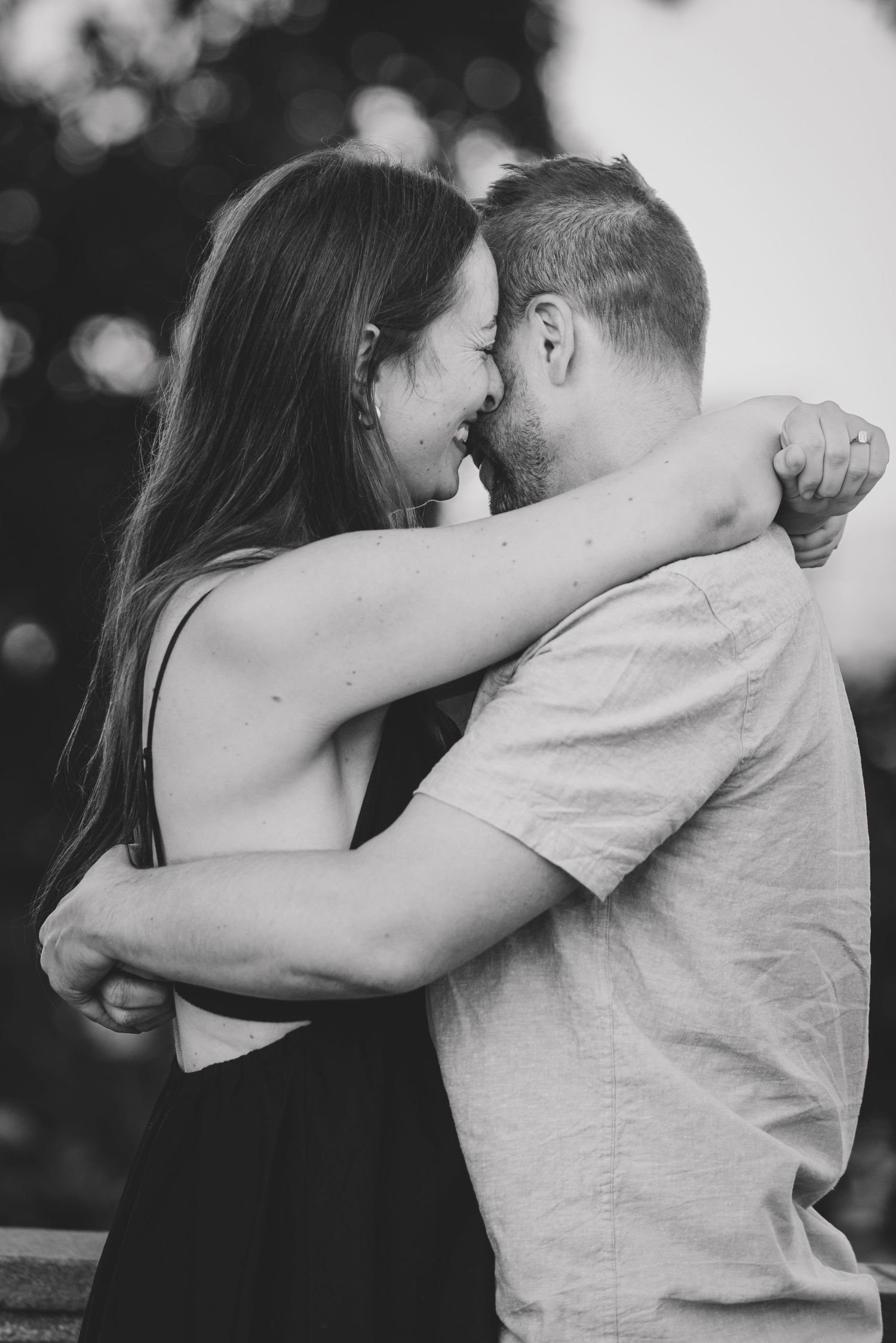 A romantic black and white photo sequence showing a couple embracing and sharing intimate moments outdoors.