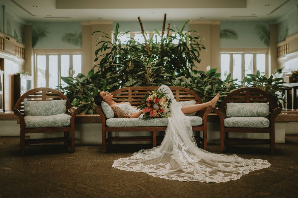 A long wedding dress train elegantly arranged across a luxury hotel hallway floor.