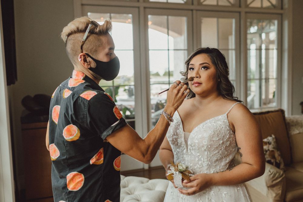Wedding preparation scene with bride in elegant white dress.